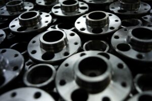 A PILE OF ROUND STEEL AUTOMOTIVE PARTS 